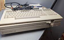 vintage Commodore 128d computer with keyboard, cords and game picture